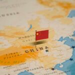 China’s Mega Carrier to DWARF US Warships Map of China with a small Chinese flag placed on it