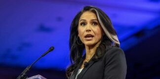 A woman speaking at a podium during a political event