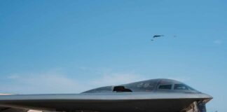 A B-2 stealth bomber on an airfield under a clear blue sky