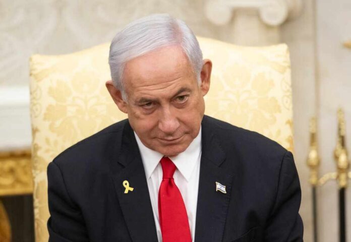 A government official with a serious expression seated in a formal setting