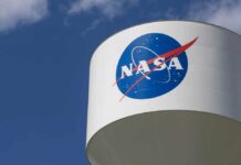 NASA logo on a water tower against a blue sky