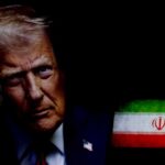 Close-up portrait of a political figure with the Iranian flag in the background
