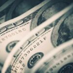 BILLION-DOLLAR Game Once Condemned by Congress Close-up of folded hundred dollar bills