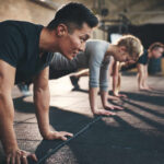 Music vs. Supplements: The Fitness Industry’s Nightmare Group of individuals performing push-ups in a gym