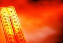 Thermometer showing high temperature against a red hot background