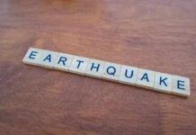 Scrabble tiles spelling earthquake on a wooden table