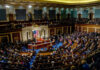 DNI Stunner: Congress Threatens FISA Blackout A large gathering of officials in a congressional chamber during a legislative session