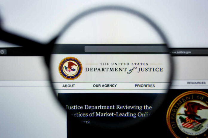 Close-up view of the Department of Justice website through a magnifying glass