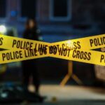 School Horror: Roof Crashes Mid-Class Police tape marking a crime scene with blurred figures in the background
