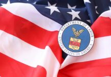 Labor Dept Hammer Drops On Scammers U.S. Department of Labor seal on an American flag