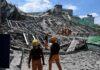 Rescue workers search a collapsed building site