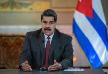Maduro Dragged In—Trial Could Shake D.C. Man speaking at podium with Cuban flag in background.