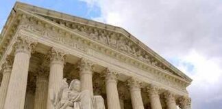 Supreme Court building with columns and statue