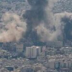 Retaliation Spiral Engulfs Bahrain, Kuwait, Qatar Smoke plumes rise over a dense cityscape