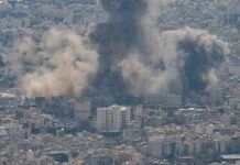 Retaliation Spiral Engulfs Bahrain, Kuwait, Qatar Smoke plumes rise over a dense cityscape