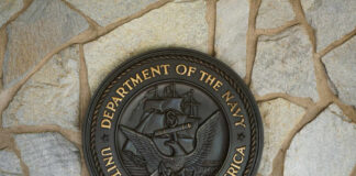 Bronze seal of the Department of the Navy mounted on a stone wall