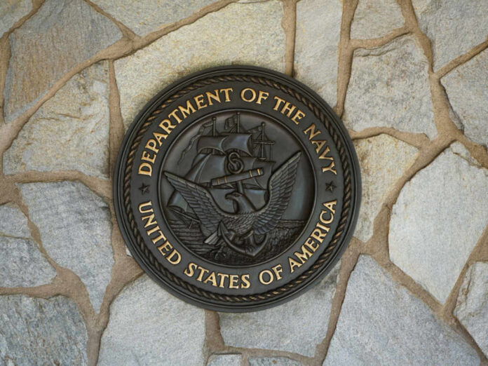 shutterstock2010674780jpg Bronze seal of the Department of the Navy mounted on a stone wall