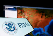 FEMA Holdback Triggers Election Brawl FEMA logo in front of a geographic map on a computer screen