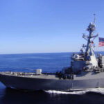 Budget Bomb: Billion-Dollar Warships A naval destroyer sailing in the ocean with an American flag