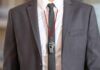 business suit with red lanyard and whistle
