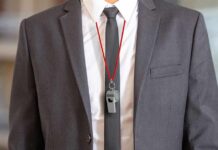 business suit with red lanyard and whistle