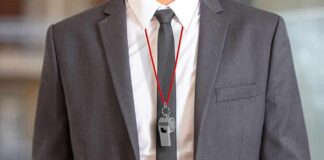 business suit with red lanyard and whistle