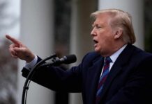 man speaking at a podium and pointing