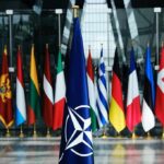 NATO Alarm As Missile Hits Poland NATO flag with member country flags in the background