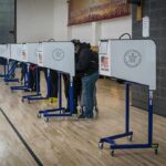 Voter Purge Fears Rattle Washington Voters at polling booths in a gymnasium