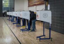 Voter Purge Fears Rattle Washington Voters at polling booths in a gymnasium
