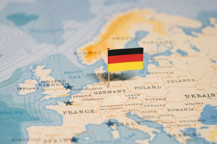 shutterstock_2324819755 Map of Europe with a small German flag pin marking Germany