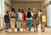 Billion-Dollar Foster Fix — Where’s The Proof? A group of children walking together in a school hallway, each carrying a backpack