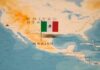 Data Games Cloud Mexico’s Murder Drop Map of North America with a flag of Mexico pinned on it