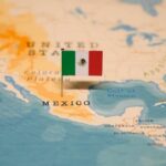 Data Games Cloud Mexico’s Murder Drop Map of North America with a flag of Mexico pinned on it