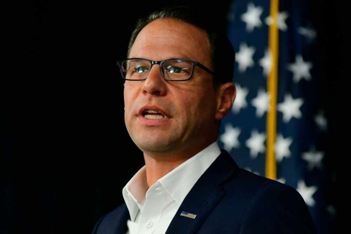 Philadelphia,,Pa,Usa,,July,30,,2024,-,Gov.,Josh,Shapiro A man in a suit speaking at a podium with an American flag in the background