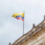 Jerusalem Gambit Jolts Latin America Colombian flag atop a neoclassical building