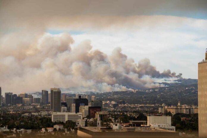 City skyline with smoke clouds from a wildfire in the background