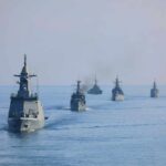 Navy’s AI Gambit — Metrics Missing, Risks Mount A fleet of military ships sailing in the ocean