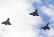 Third Strike Teased—Tehran on Edge Three fighter jets flying in formation against a cloudy sky