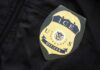 Night Cruise Capsize Sparks Federal Crackdown ICE officer badge on a dark uniform