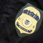 Night Cruise Capsize Sparks Federal Crackdown ICE officer badge on a dark uniform