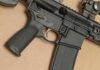 AR-style rifle close-up with grip, trigger, and magazine