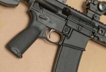 AR-style rifle close-up with grip, trigger, and magazine