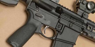 AR-style rifle close-up with grip, trigger, and magazine
