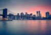 Brooklyn Bridge over East River at sunset with Manhattan skyline