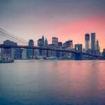 Brooklyn Bridge over East River at sunset with Manhattan skyline