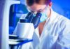 Scientist using a microscope in a lab