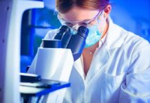 Scientist using a microscope in a lab