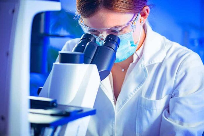 Scientist using a microscope in a lab