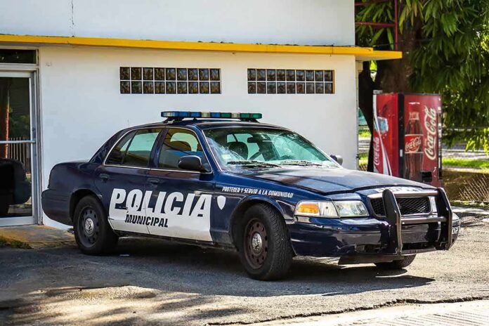 municipal police car parked by a building